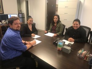 Staff members of the Lawyer Referral Service sitting around a conference table.