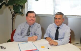 Picture of Volunteer Robert Unetic with CLS SoCal directing attorney Renato Izquieta sitting at a table.